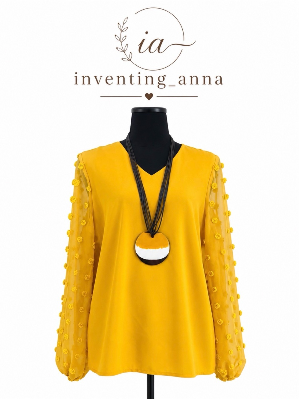 Women’s V-neck mustard yellow top w/sheer sleeves and raised circle accents